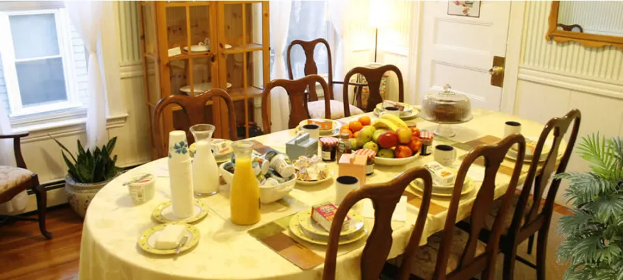 The breakfast table set with fruit, juice and pastries