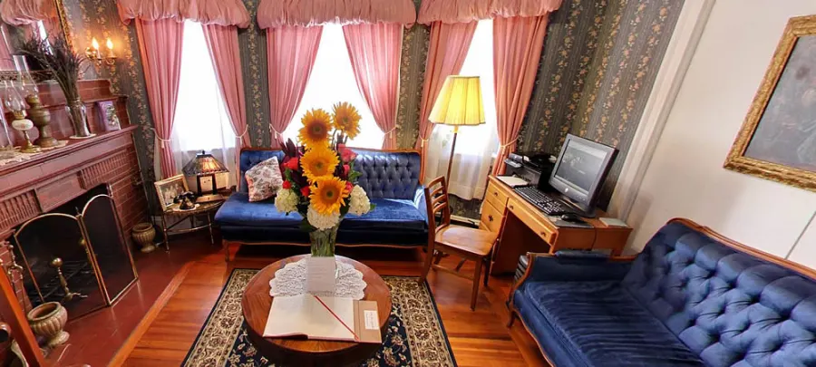 The sitting room with blue tufted sofas and sunflowers